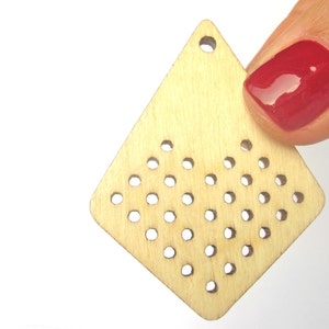 May include: A light wood diamond-shaped pendant with a hole at the top and a grid of small holes throughout the surface.