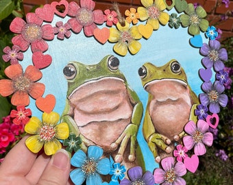 Heart Shaped Painting of Two Frogs on Wood, with a Rainbow Floral Frame. Hand painted, unique one of a kind. Eco friendly shipping materials