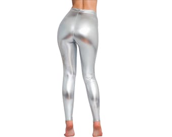 May include: High-waisted leggings in a metallic silver finish with a smooth, reflective surface. These form-fitting trousers feature a simple, seamless design that extends from the waist down to the ankles, showcasing a bright, shiny appearance.