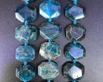 May include: A strand of blue apatite gemstone beads, each bead is faceted and has a unique pattern. The beads are strung on a clear thread and are ready to be used for jewelry making.
