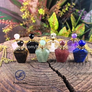 Puede incluir: Siete botellas de perfume de piedras preciosas en cadenas doradas. Las botellas están hechas de ojo de tigre, ónix negro, aventurina, cuarzo transparente, cuarzo rosa, amatista y lapislázuli.