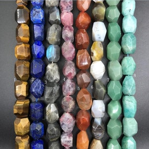 May include: Eight strands of faceted gemstone beads, each strand is a different colour and labelled with a number 1 through 8. The beads are in a variety of colours including brown, blue, grey, pink, red, white, green, and black.