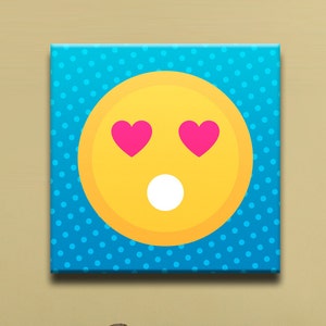 May include: A yellow smiley face with pink hearts for eyes and a white open mouth on a blue background with white polka dots.