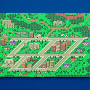 May include: A pixelated map of a town with green grass, trees, and houses. The town has a central square with a building that looks like a courthouse. There are roads and pavements throughout the town.