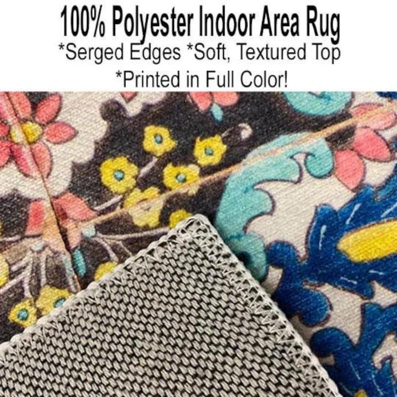 May include: A close-up of a colorful area rug with a floral pattern. The rug is made of 100% polyester and has serged edges. The rug is soft and textured and is printed in full color.