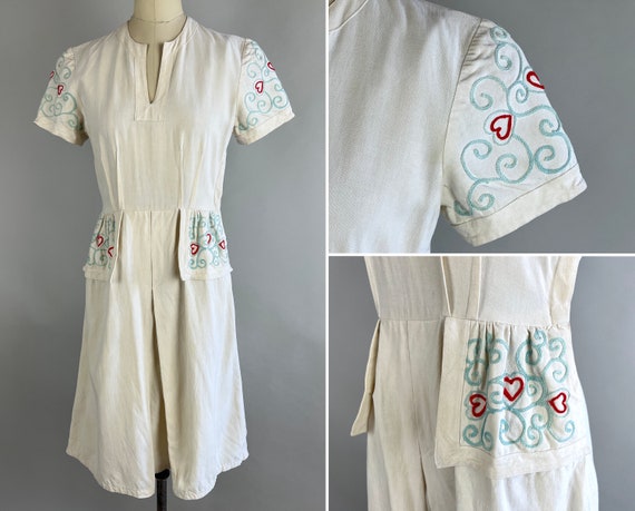 1930s Cupid's Target Dress | Vintage 30s White Cotton Linen Day Frock with Blue and Red Novelty Heart & Swirl Embroidery and Pockets | Small