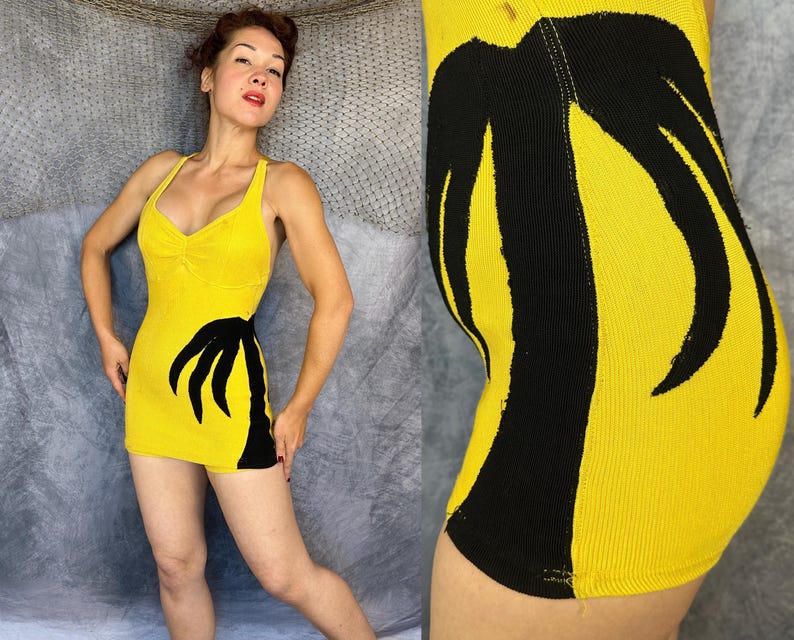 May include: A bright yellow sleeveless mini dress featuring a prominent black palm tree graphic on the side. The garment has a scoop neckline with subtle ruching at the center of the bust and a fitted silhouette that ends at the upper thigh.