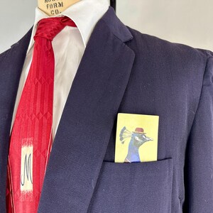 May include: A white ceramic mug with a black handle and the text "But First, Coffee" in a black, bold font. The mug is sitting on a white surface. The mug is approximately 4 inches tall.