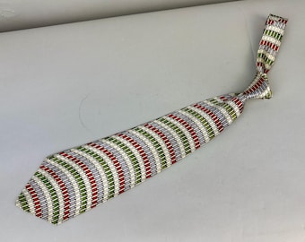 May include: A patterned necktie with a repeating design of red, green, and gray stripes. The tie is knotted and lies on a light gray surface. The tie's design is a series of curved lines, creating a textured appearance.