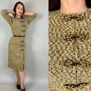May include: A two-piece vintage outfit featuring a textured knit top and pencil skirt in shades of brown and beige. The top has decorative gold-toned clasps and a matching belt. The skirt has a slit at the hem.