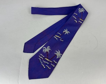 May include: A deep purple necktie featuring a repeating pattern of small tropical islands with palm trees and stylized waves. The palm trees are depicted in light gray with dark red trunks, while the islands are yellow and the waves are white.