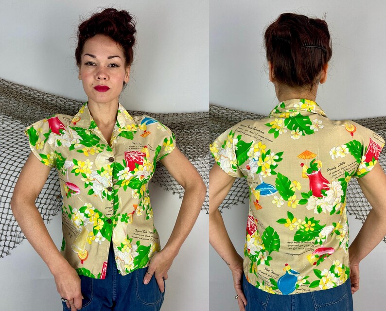 May include: Tan short-sleeved button-up shirt with a tropical floral print featuring red, yellow, and green elements. The shirt has a classic collar and wooden buttons. The print includes illustrations of drinks and text.