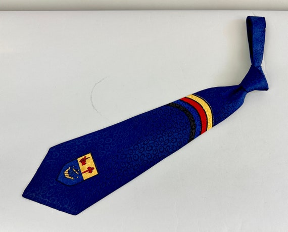 1940s Regal Reginald Necktie | Vintage 40s Cobalt Blue Rayon Jacquard Self Tie Cravat with Yellow and Red Ship Crest Imagery