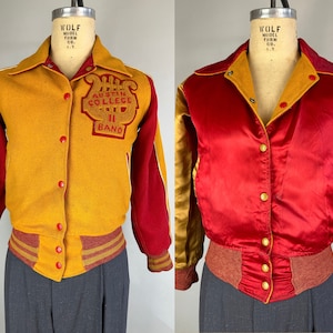 May include: Two vintage letterman jackets. The first is gold and red with "Austin College Band" lettering. The second is red satin with gold sleeves. Both have button closures and ribbed cuffs. The jackets are displayed on a mannequin.
