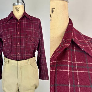 May include: A white ceramic mug with a black handle and the text "But First, Coffee" in a black, bold font. The mug is on a white surface.