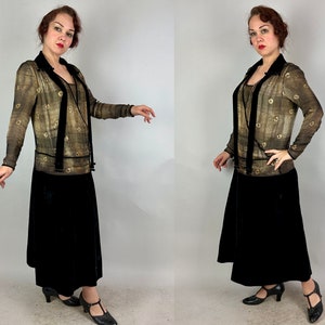 May include: A vintage-style dress with a sheer, gold-toned top and a black velvet skirt. The top features a geometric pattern and a velvet sash.