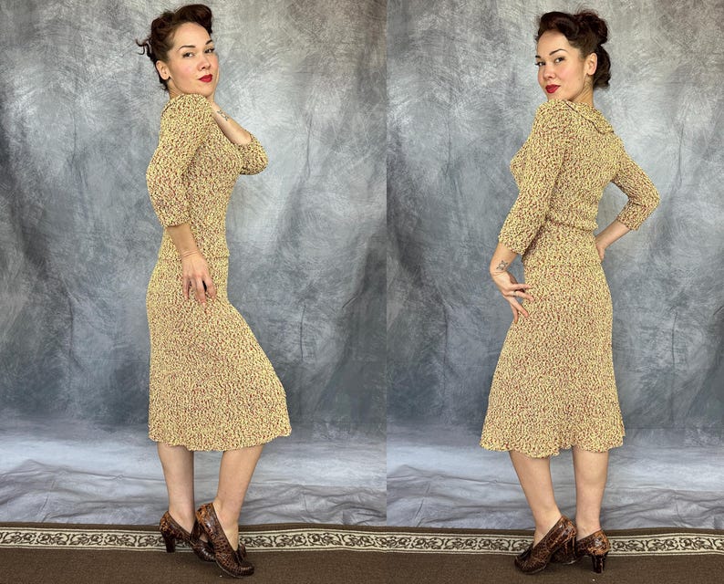 May include: A vintage two-piece knit dress in a speckled pattern of tan and burgundy. The set includes a long-sleeved top and a knee-length skirt. The model is wearing matching patterned heels.
