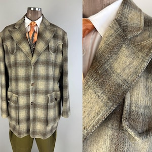 Puede incluir: Una chaqueta de lana a cuadros marrón y beige con dos bolsillos de solapa y cierre de botón. La chaqueta tiene solapa de muesca y un solo botón en el puño.