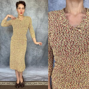 May include: A vintage two-piece knit set in a speckled pattern of yellow, red, and brown. The top has a V-neck and three-quarter sleeves. The skirt is knee-length. The outfit is a classic example of mid-century fashion.