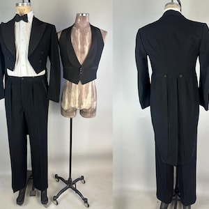 May include: A formal black tuxedo with a white dress shirt, black bow tie, and black trousers. A black vest is displayed next to the tuxedo. The back of the tuxedo shows a long tailcoat design.