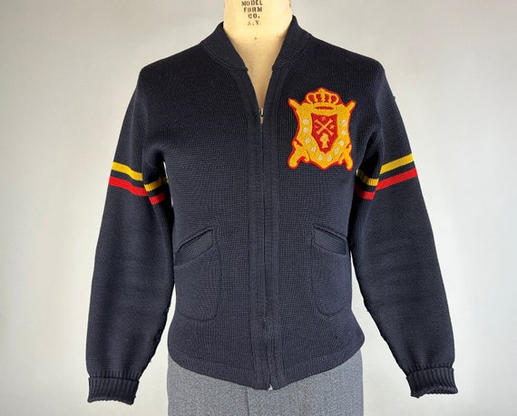 1940s Colorful Crested Cardigan | Vintage 40s Black Wool Zip-Up Sweater with Red and Yellow Collegiate Stripes & School Patch | Medium/Large