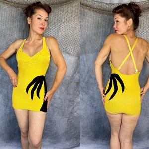 May include: A bright yellow sleeveless mini dress featuring a sweetheart neckline and a bold black palm leaf graphic on the side. The garment has thin, adjustable crisscross straps on the back and a fitted silhouette that ends at the upper thigh.
