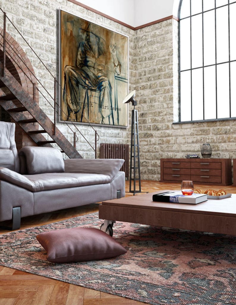 May include: A living room with a large painting of a person sitting on a chair. The painting is on a brick wall. There is a couch, a coffee table, and a rug in the room. The coffee table has a book and a glass of wine on it.