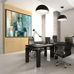 May include: A modern office with a large abstract painting of a person wearing a hat and sitting in a chair. The painting is on a wall with wood paneling. There is a large black desk with two black office chairs and a black desk lamp.