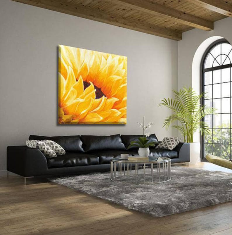 May include: A close-up of a painting depicting a yellow sunflower with a dark brown center. The sunflower is the only subject in the painting and fills the entire canvas.