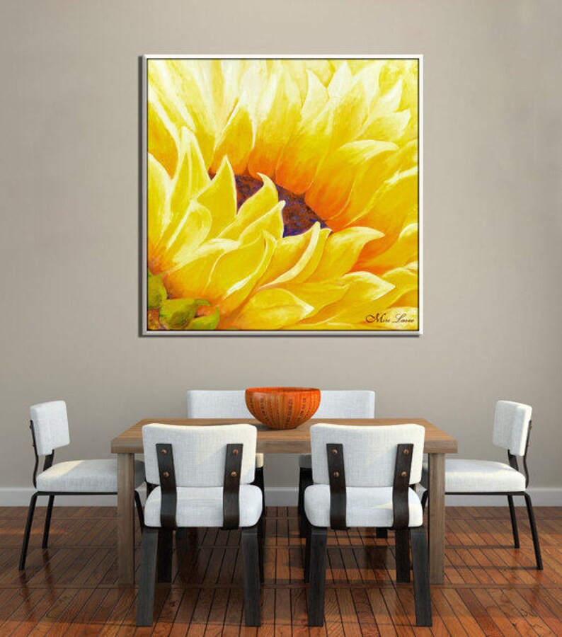 May include: A close-up of a yellow sunflower painting with a white frame. The painting is signed "Miss Lane" in the bottom right corner.