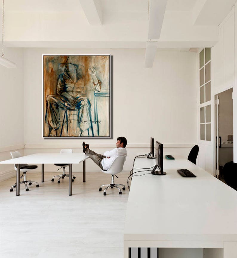 May include: A white office with a large abstract painting of a person sitting in a chair. The painting is in shades of brown, blue, and white. The painting is hanging on a white wall. There is a white desk in the foreground with a person sitting in a chair with their feet up on the desk. The desk has a computer monitor and a keyboard on it. The room has a white ceiling and white walls.
