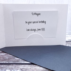 May include: A white card with a message inside. The message reads "To Megan, On your special birthday, Love always, Jane XXX".