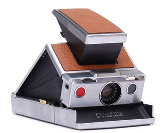 Vintage polaroid sx-70 instant camera - refurbished classic slr with manual focus and film shield