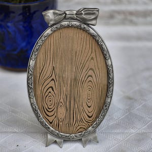 Ornate Floral Pewter Oval Picture Frame with Bow Detail for a 5x7 Inch Photo by Burnes of Boston