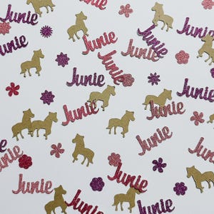 May include: Pink and gold glitter confetti with the name "Junie" and horse silhouettes.