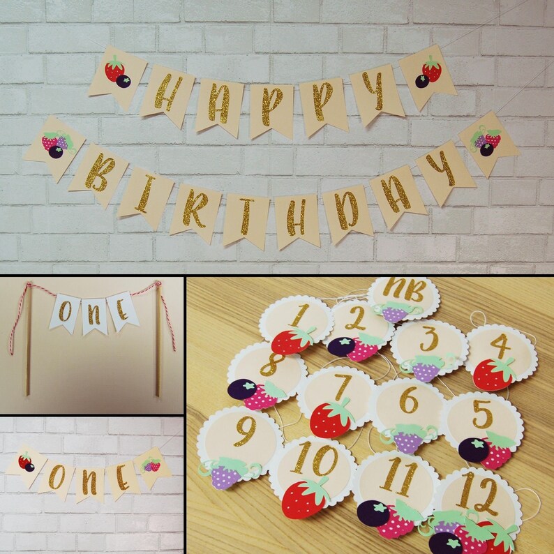 May include: A set of gold glitter birthday banner decorations with the words "Happy Birthday" and "One". The banner is decorated with berry and fruit illustrations. There are also 12 individual circle decorations with numbers 1-12 and berry illustrations.