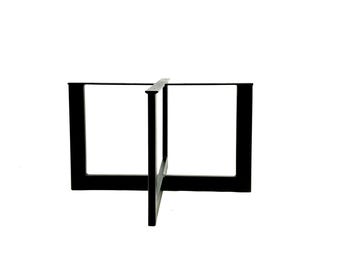 May include: Black metal table base with a square design. The base has four legs that are connected in the middle by a cross shape.