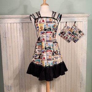 May include: A black and white vintage-style apron with a ruffled hem and a print of various advertisements. The apron has two matching pot holders with the same print.