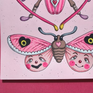 May include: A pink and white butterfly with a heart-shaped design on its wings. The butterfly has a cartoon-like face with large eyes and a smile. The butterfly is on a pink background.