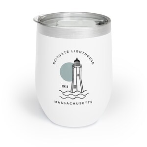 May include: White stainless steel travel mug with a black and white graphic of the Scituate Lighthouse, Massachusetts. The graphic includes the text "Scituate Lighthouse", "1811", and "Massachusetts".