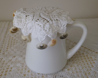 Vintage white knitted jug cover with shells