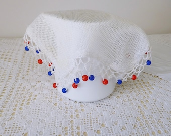 Vintage white mesh jug cover with red and blue beads