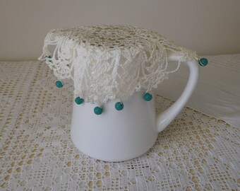 Vintage white beaded jug cover, turquoise beads