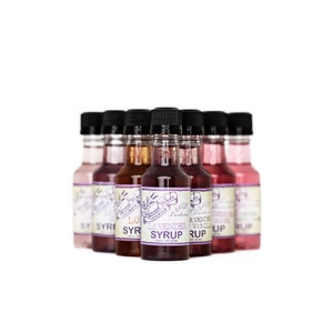 May include: A set of eight small glass bottles with colorful liquids and labels. The labels have a vintage design and include the text "Lavender Syrup", "Vanilla Syrup", "Lemon Syrup", and "Rose Syrup".