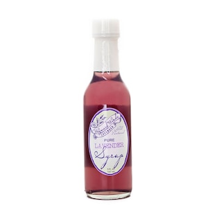 May include: A glass bottle of pure lavender syrup with a white label that says "Wayward Winds Lavender & All Natural Pure Lavender Syrup 5 fl oz 147 ml".