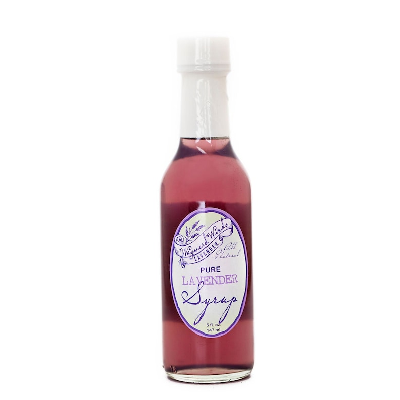 May include: A glass bottle of pure lavender syrup with a white label that says "Wayward Winds Lavender & All Natural Pure Lavender Syrup 5 fl oz 147 ml".