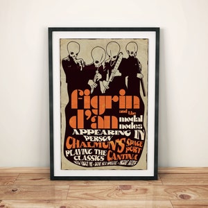May include: Framed poster with a retro design, featuring the text "Figrin D'an and the Modal Nodes" in orange and white. The poster shows four alien figures playing instruments. The poster is in a black frame and is displayed on a wooden floor.
