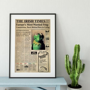 May include: A vintage newspaper clipping with a photo of Kermit the Frog, the headline reads "Europe's Most Wanted Frog: Constantine, Back Behind Bars in Gulag".