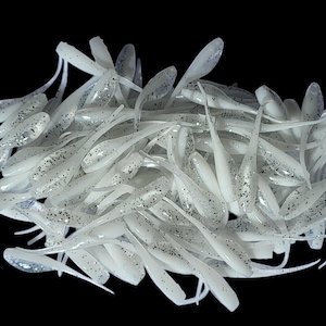 May include: A set of three ceramic mugs with a speckled, matte finish. The mugs are in shades of cream, light gray, and dark gray. Each mug has a simple, modern design and a rounded handle.