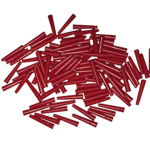 May include: A pile of small, red, cylindrical objects with a tapered end. The objects are scattered against a white background. The items appear to be made of a smooth, solid material.